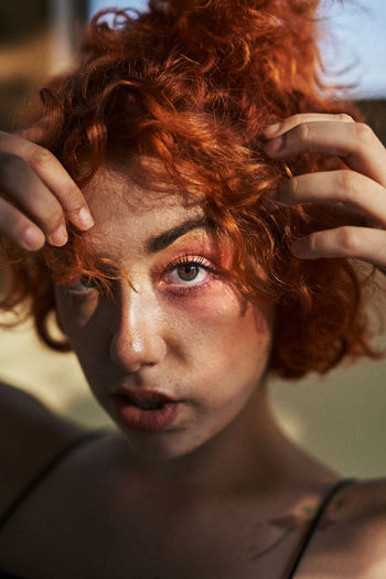 Young alternative redhead girl close up with green eyes