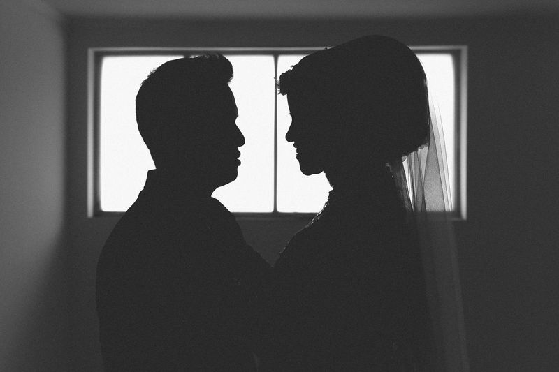 Side view of silhouette newlywed couple in darkroom