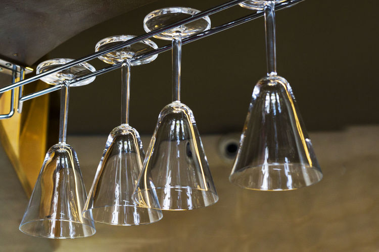 Close-up of upside down hanging on table, martini glass