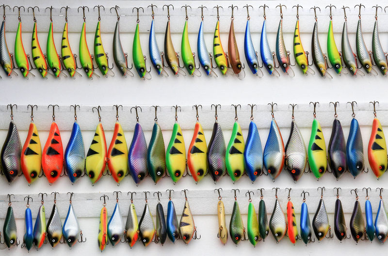 Full frame shot of colorful fishing tackles hanging on wall