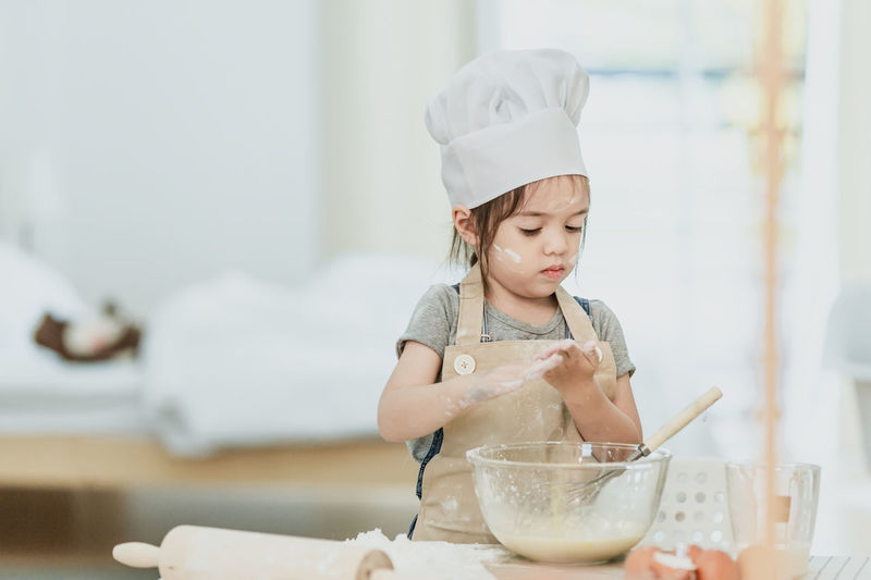 Girl looking away in bowl at home