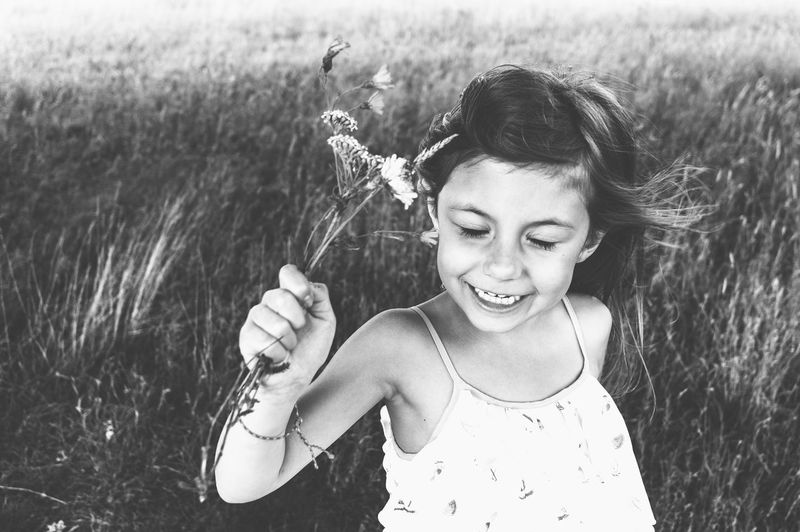 Portrait of smiling girl holding a field