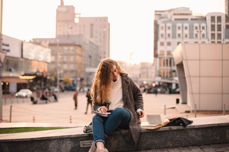 Woman sitting in city