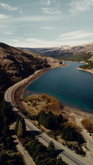 High angle view of road by bay against sky