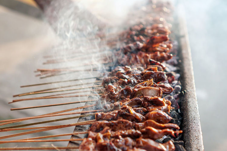 The seller is grilled satay. 