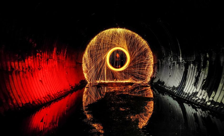 Person standing against wire wool in tunnel