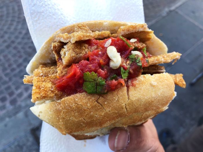 Close-up of hand holding burger