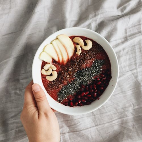 Vegan smoothie bowl for breakfast with fruit, nuts, seeds and cereal