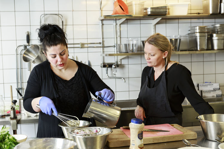 Women preparing food in restaurant kitchen
