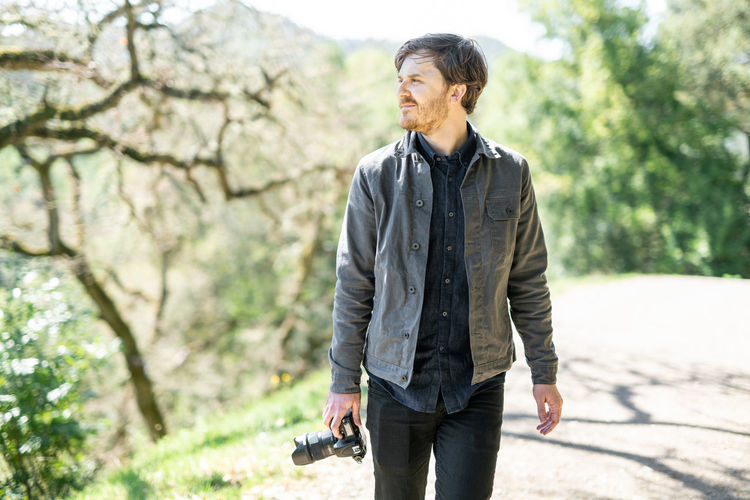 Portrait of hiker out shooting photos on sunny day in california