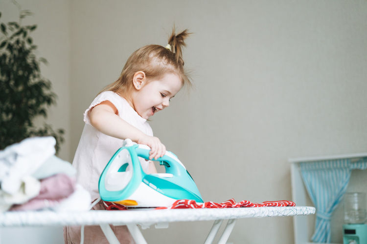 Portrait of boy playing with toy at home