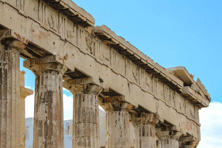 Columns at acropolis of athens against sky