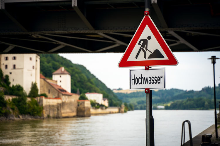 Road sign by river