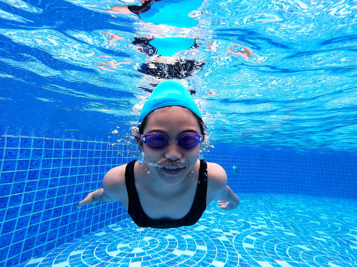 Portrait of girl swimming in pool