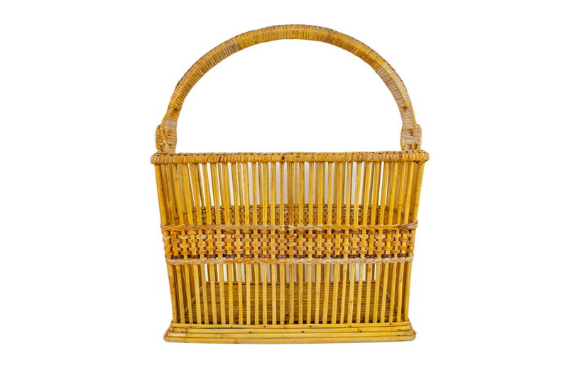 Close-up of yellow basket over white background