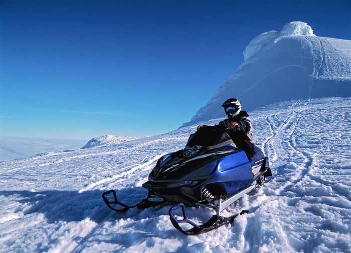Man riding his snow scooter on snaefellsnesjokull glacier