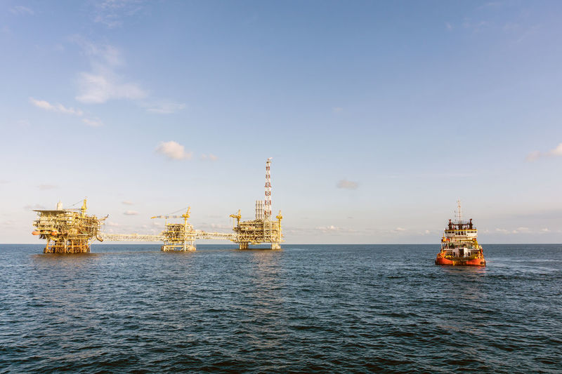 A boat approaching a oil production platform complex at terengganu oil field