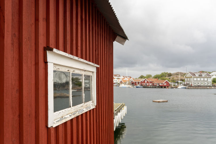Building by river against sky