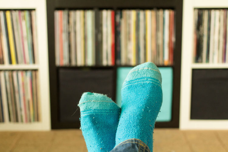 Low section of person wearing socks at home
