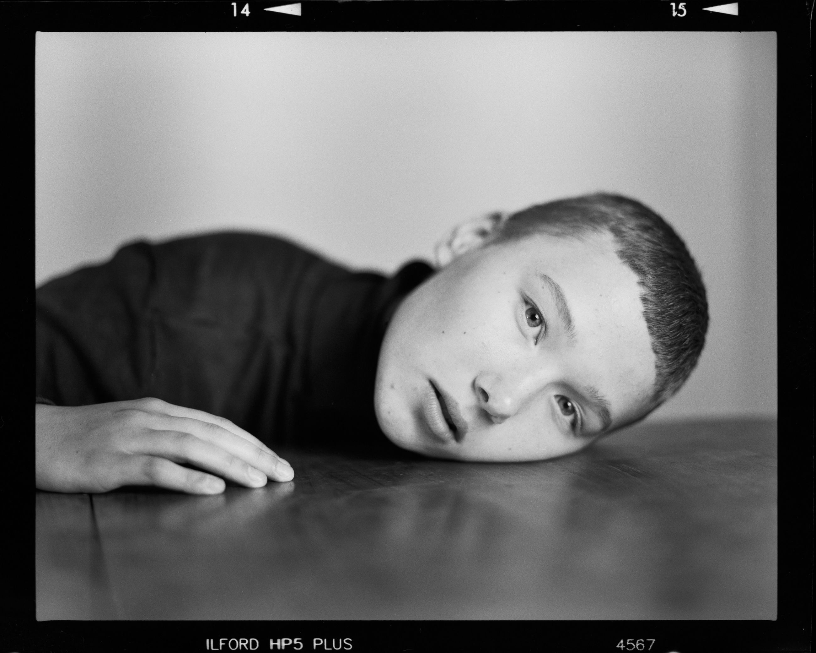 one person, transfer print, men, indoors, males, auto post production filter, looking at camera, portrait, real people, child, boys, headshot, childhood, table, front view, lifestyles, close-up, relaxation, human face, innocence, teenage boys, teenager