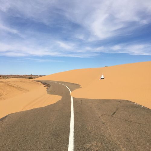 Scenic view of desert against sky, in the sahara desert in mauritania. big road full of sand 