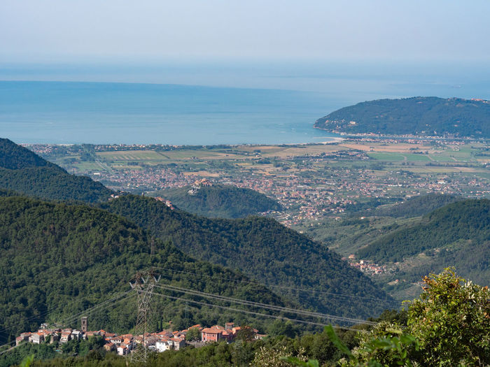 High angle view of landscape and sea against sky