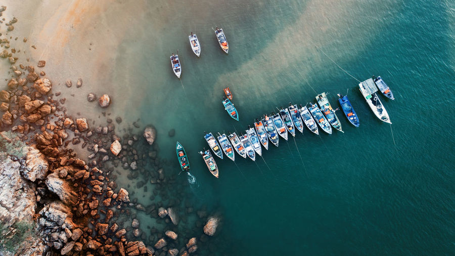 High angle view of boats on sea shore