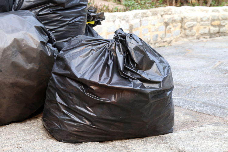 Close-up of garbage bags on road