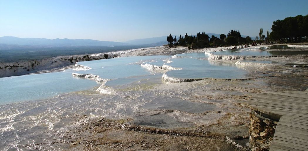 Scenic view of travertine pool against clear sky at pamukkale