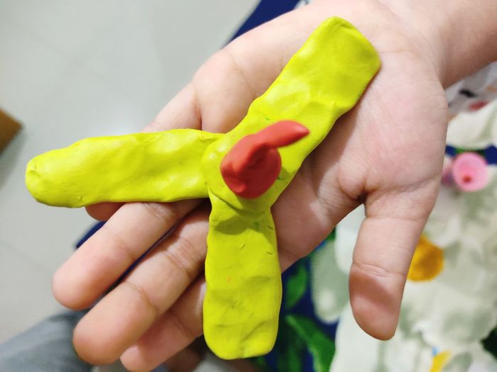 Close-up of hand holding clay