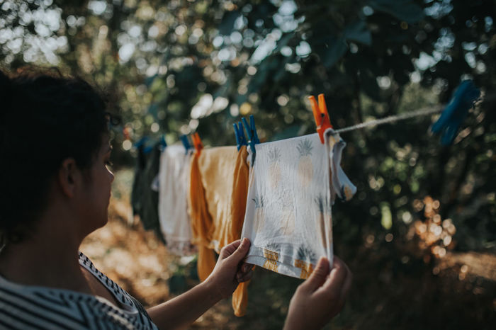 Woman drying laundry on clothesline