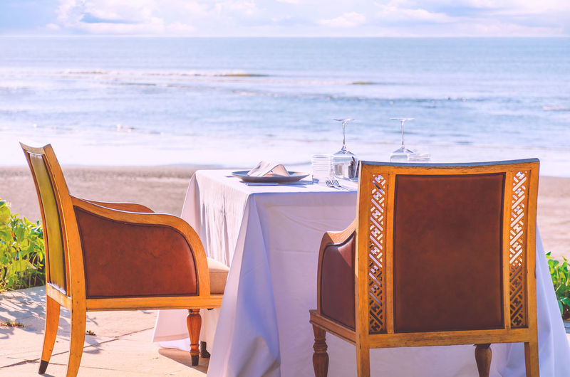 Table in a restaurant or resort by the sea beach served for two.