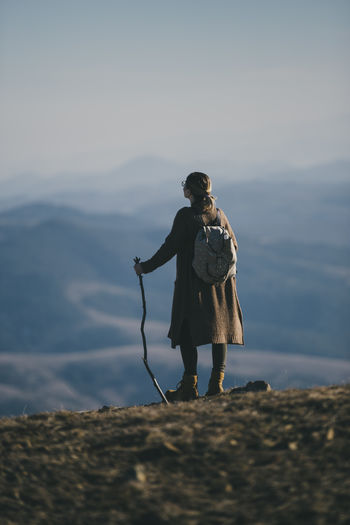 Rear view of woman hiking on mountain 
