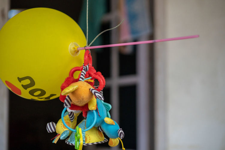 Close-up of multi colored balloon hanging on rope