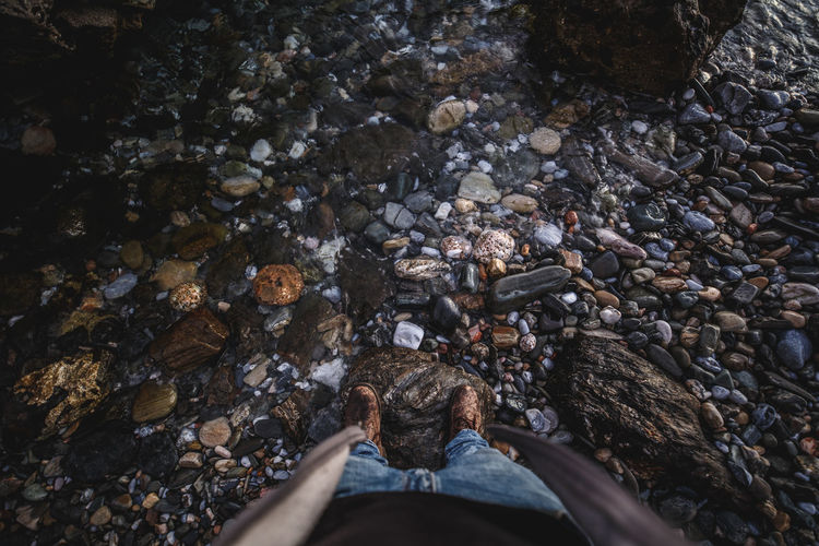 Low section of person standing on rock