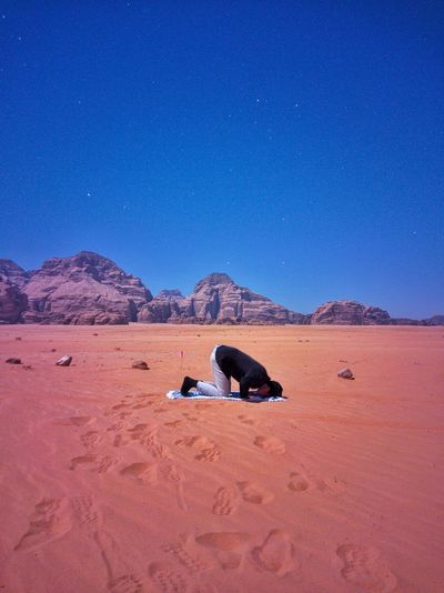 Muslim praying in desert