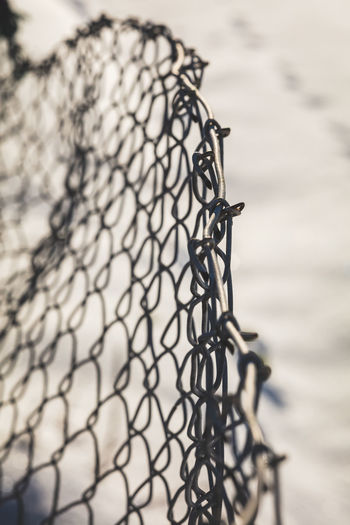 Close-up of bicycle on metal fence