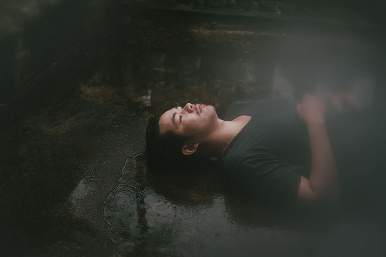 Portrait of young woman lying in water