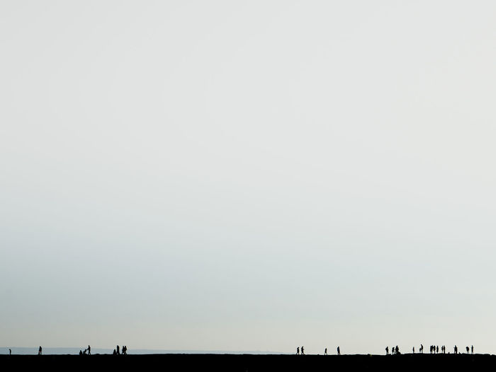 Low angle view of silhouette built structure against clear sky