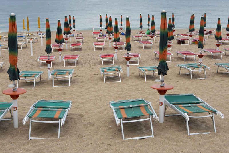 High angle view of empty chairs and tables at beach
