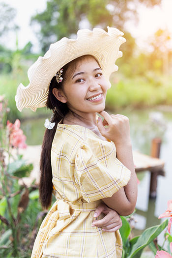 Portrait of smiling girl standing against plants