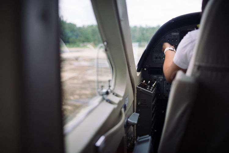 Midsection of woman sitting in air vehicle