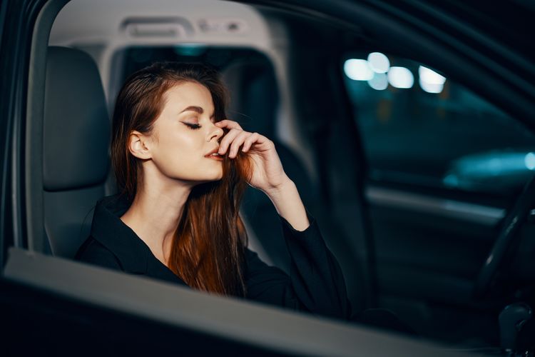 Young woman sitting in car