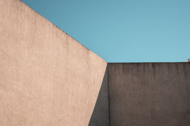 Concrete wall against clear blue sky