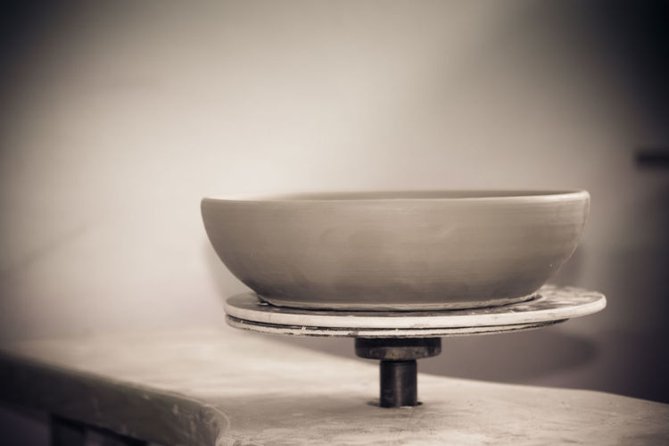 Close-up of old bowl on table at home
