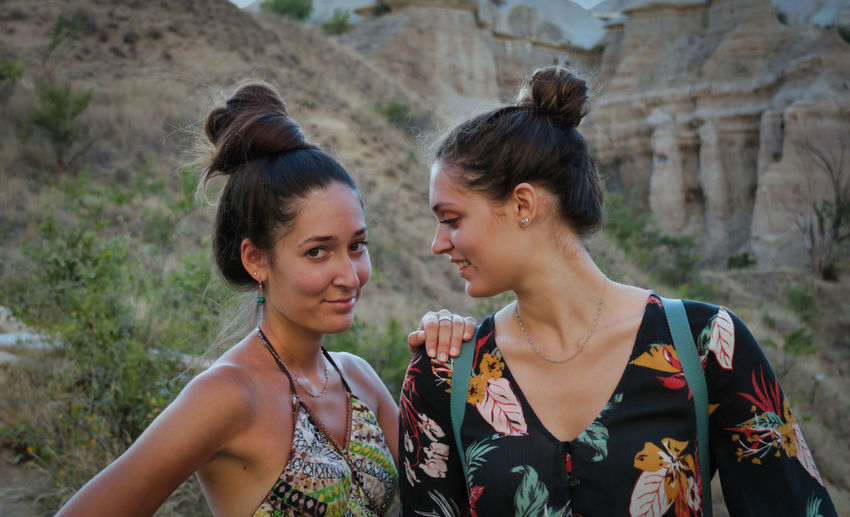 Portrait of two caucasian sister having fun during holidays on mountain in summer