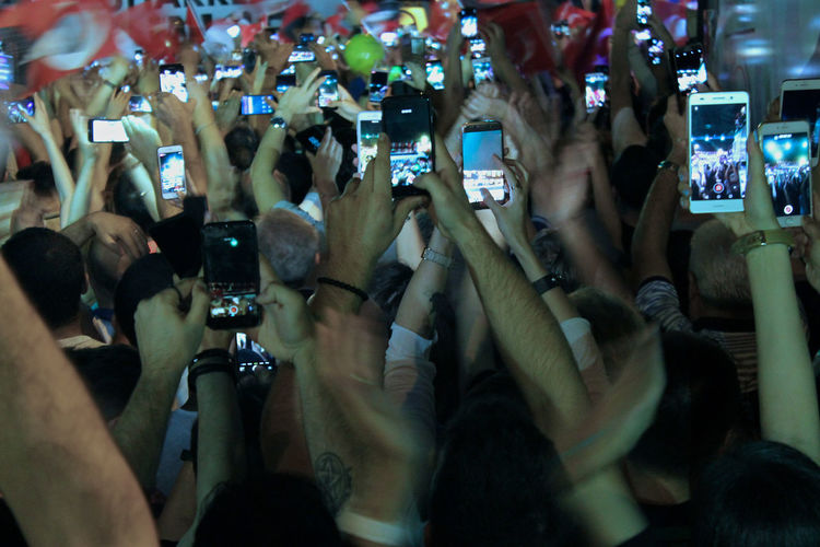 People photographing music concert