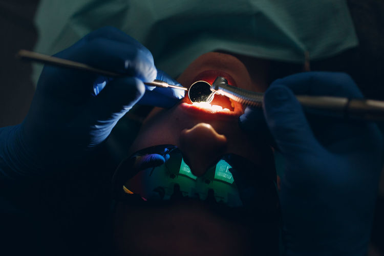 Close-up of dentist checking patient