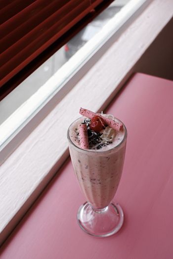 High angle view of milkshake in glass on table