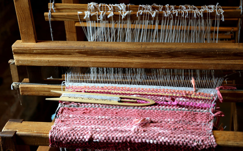 Close-up of weaving loom with shuttle